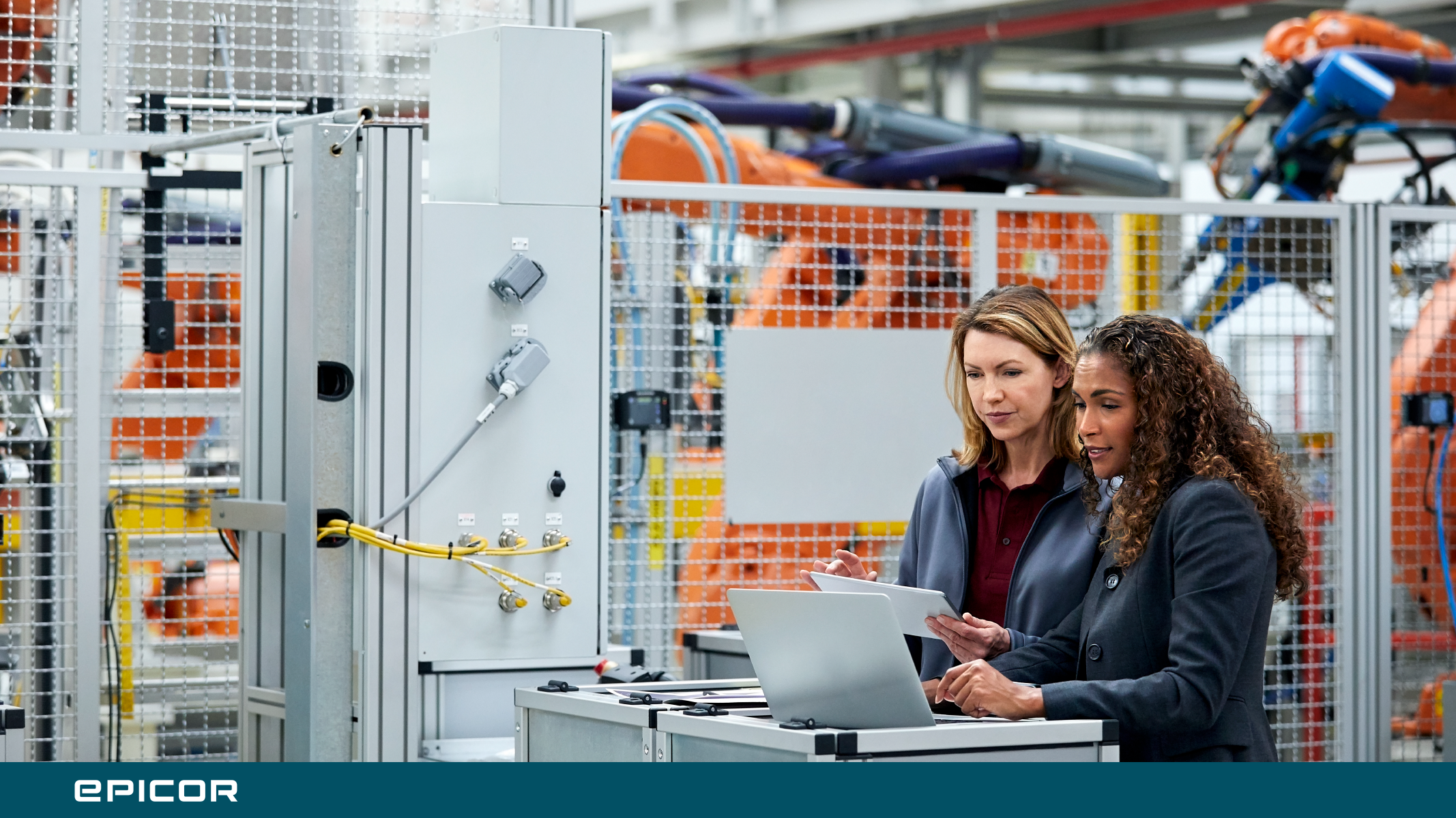 Manufacturing cell with operators viewing laptop