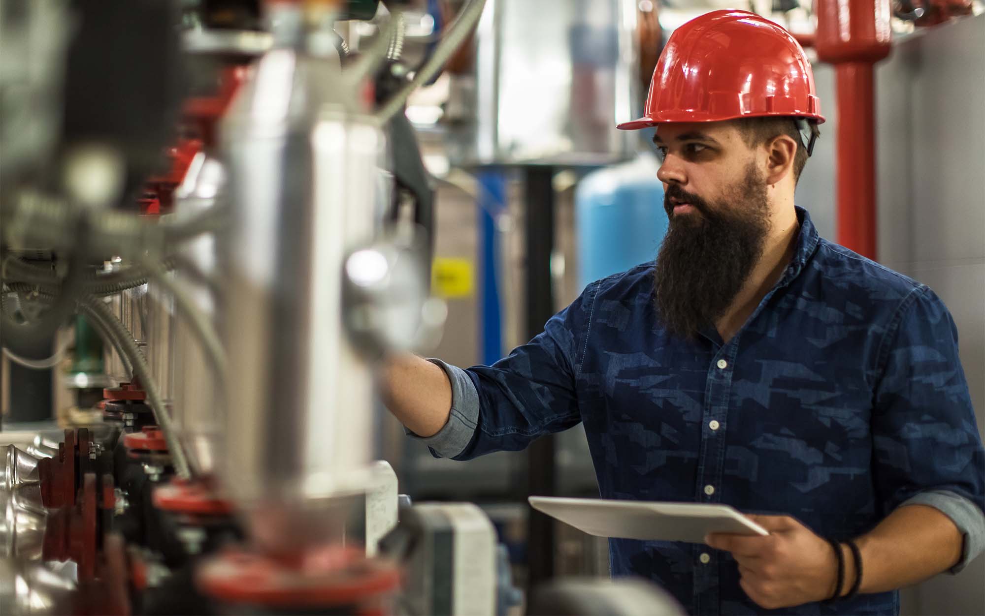 A technician using digital work instructions to maintain safety requirements.
